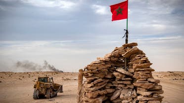 In this file photo taken on November 23, 2020, a bulldozer passes by a hilltop manned by Moroccan soldiers on a road between Morocco and Mauritania in Guerguerat located in the Western Sahara. (Fadel Senna/AFP)