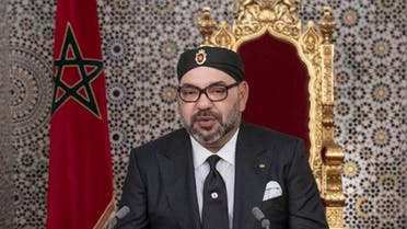 This handout picture provided by the Moroccan Royal Palace on July 29, 2019 shows Morocco's King Mohammed VI (C) delivering a speech marking the 20th anniversary of his accession to the throne. (AFP)