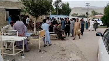 People gather outside a hospital following an earthquake in Harnai, Balochistan, Pakistan, October 7, 2021, in this still image obtained from video. (Reuters)