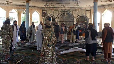 Taliban fighters investigate inside a Shiite mosque after a suicide bomb attack in Kunduz on October 8, 2021. (AFP)
