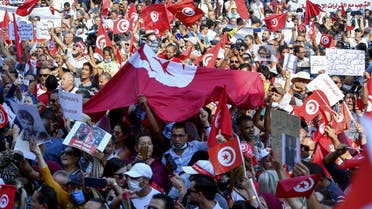 Tunisians chant slogans supporting President Kais Saied during a rally at the Habib Bourguiba avenue in the capital Tunis, on October 3, 2021. Saied on July 25 suspended the legislature, sacked the government and seized control of the judiciary, later moving to rule by decree.