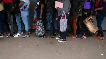 Haitian migrants queue to register with the National Commission for Refugees (COMAR) in Tijuana, Baja California state, Mexico on October 6, 2021, in Mexico. (Guillermo Arias/AFP)