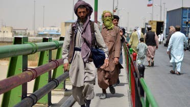 Afghan men walk towards an Afghan-Iran border crossing in Zaranj on September 8, 2021. (AFP)
