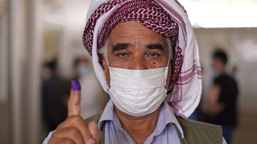 A displaced Yazidi shows his ink-stained finger after casting his vote for the parliamentary elections at a camp in the Sharya area, some 15 kilometres from the northern city of Dohuk in the autonomous Iraqi Kurdistan region, on October 8, 2021. Security forces, displaced people and prisoners cast ballots in an Iraqi legislative election, two days before the rest of the country in a poll overshadowed by expectations of a low turnout.