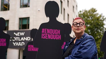 British Comedian Jo Brand poses next to silhouettes of women, outside New Scotland Yard, in London, Thursday, Oct. 7, 2021, as part of Refuge's campaign 'Enough is enough' to include domestic abuse, domestic homicide, and sexual violence in the serious violence duty in the Police, Crime, Sentencing and Courts Bill. (AP)