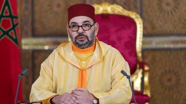 A picture released by the Moroccan Royal Palace shows Morocco’s King Mohammed VI addressing speech, transmitted via a screen to the parliament, from the Royal Palace in the northeastern city of Fez, on October 8, 2021. (Moroccan Royal Palace/AFP)