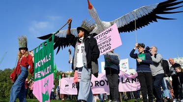Environmental campaigners part in a march and delivery of a petition to the Buckingham Palace, demanding that the British royal family rewild their land, ahead of the COP26 climate summit due to take place in November, in London, Britain. (Reuters)