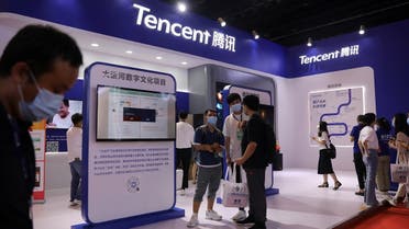 People are seen at a booth of Tencent at an exhibition during China Internet Conference in Beijing, China, on July 13, 2021. (Reuters)