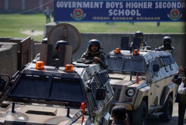 Indian security forces keep guard atop armored vehicles, outside a government school after suspected militants shot and killed two teachers in Srinagar, on October 7, 2021. (Reuters)