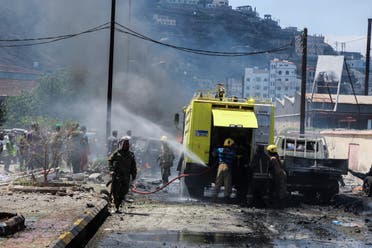 Policemen stand at the scene of a blast in Aden, Yemen, October 10, 2021. (Reuters)
