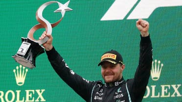 Mercedes’ Valtteri Bottas celebrates with the trophy on the podium after winning the Formula One F1 - Turkish Grand Prix race at Intercity Istanbul Park, Istanbul, Turkey, on -October 10, 2021. (Reuters)