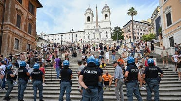 Protestors stand in front of riot police officers during a demonstration against the introduction of a mandatory green pass in the aim to limit the spread of the Covid-19, called by far right Forza Nuova party activists and Io Apro” (I open up) group of restaurant owners and workers, entrepreneurs and small businesses owners on July 27, 2021 at Piazza di Spagna by the Spanish Steps, below the Trinita dei Monti church, in Rome. (AFP)