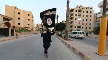 A member loyal to the Islamic State in Iraq and the Levant (ISIL) waves an ISIL flag in Raqqa June 29, 2014. (Reuters)