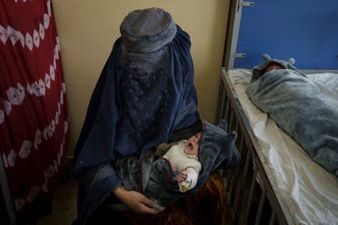  A woman holds one of her two babies undergoing treatment at the malnutrition ward of the Indira Gandhi Children's Hospital in Kabul, Afghanistan, Tuesday, Oct. 5, 2021. (AP)