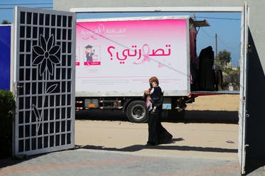 A Palestinian woman leaves a mobile clinic set up in a truck after a breast cancer check up, during a campaign aimed to raise public awareness in Gaza over the need for early tests to discover breast cancer, in Khan Yunis, in the southern Gaza Strip, October 7, 2021. (Reuters)