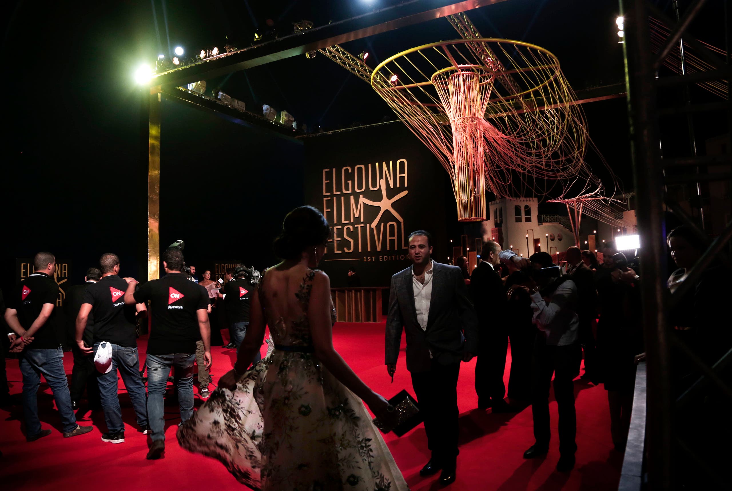 People walk on the red carpet during the first International El Gouna Film Festival, in the Red Sea resort of el-Gouna, Egypt, Friday, Sept. 22, 2017. (AP)