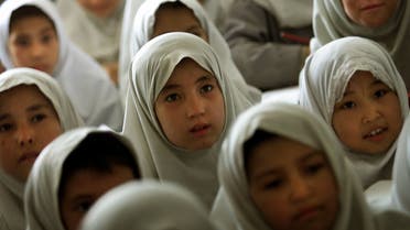 Afghan girls listen to their volunteer teacher in a humble school for unregistered refugees outside the southern Iranian town of Mashad, near the border with Afghanistan June 20, 2001. (File photo: Reuters)