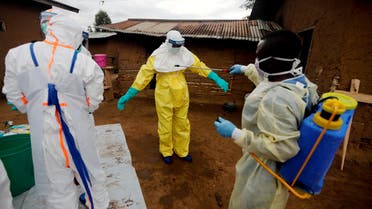 File photo of a healthcare worker who volunteered in the Ebola response, decontaminating his colleague after he entered the house of 85-year-old woman, suspected of dying of Ebola, in the eastern Congolese town of Beni in the Democratic Republic of Congo, October 8, 2019. (Reuters)