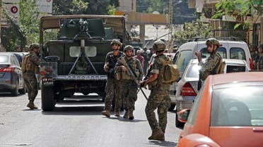 Lebanese Army soldiers take a position in the area of Tayouneh, in the southern suburb of the capital Beirut on October 14, 2021, after clashes following a demonstration by supporters of Hezbollah and the Amal movement. (AFP)