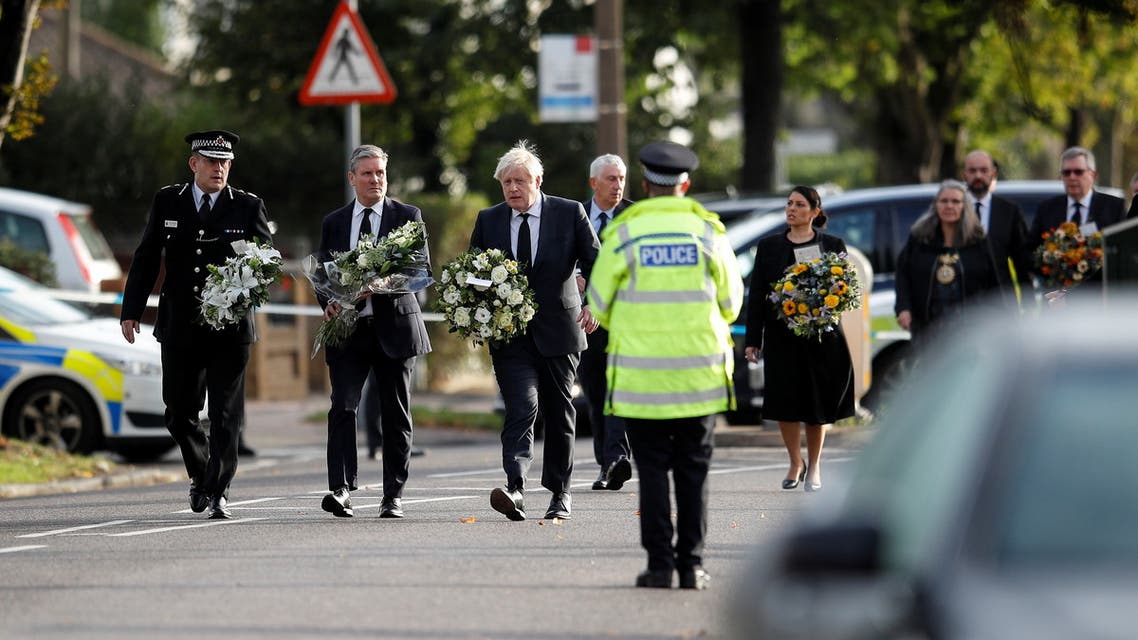 Britain's Labour Party leader Keir Starmer, Prime Minister Boris Johnson and Home Secretary Priti Patel hold flowers as they arrive at the scene where British MP David Amess was stabbed to death during a meeting with constituents at the Belfairs Methodist Church, in Leigh-on-Sea, Britain, October 16, 2021. REUTERS/Peter Nicholls