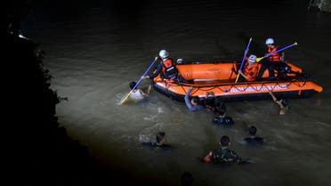  Rescuers search for victims of drowning in a river in Ciamis, West Java, Indonesia, Friday, Oct. 15, 2021. A number of students drowned during a school outing for a river cleanup on Friday evening in Indonesia's West Java Province. (AP Photo/Yopi Andrias)