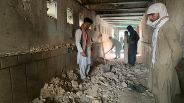  People inspect the inside of a mosque following a suicide bombers attack in the city of Kandahar, southwest Afghanistan, Friday, Oct. 15, 2021. Suicide bombers attacked a Shiite mosque in southern Afghanistan that was packed with worshippers attending Friday prayers, killing several people and wounding others, according to a hospital official and a witness. (AP)