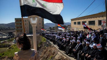 In this Feb. 14, 2021 file photo, Druse supporters of Syrian President Bashar Assad wave Syrian flags during a rally close to the border demanding the return of the Golan Heights, captured by Israel in 1967, in Majdal Shams, Golan Heights. (AP)