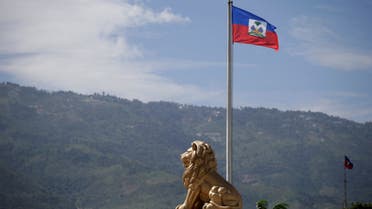 FILE PHOTO: The Haitian flag is seen next to the statue of a lion at the Court of Cassation (Supreme Court) in Port-au-Prince, Haiti October 5, 2020. (File Photo: Reuters)