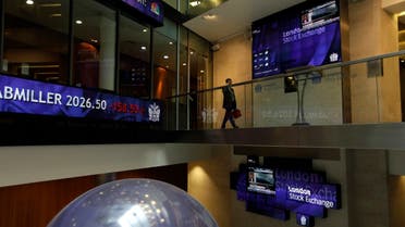 A man walks past screens inside the London Stock Exchange in the City of London. (AP)