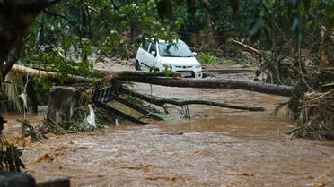 A car stucked in mud waters is pictured after flash floods caused by heavy rains at Thodupuzha in India's Kerala state on October 16, 2021. (AFP)
