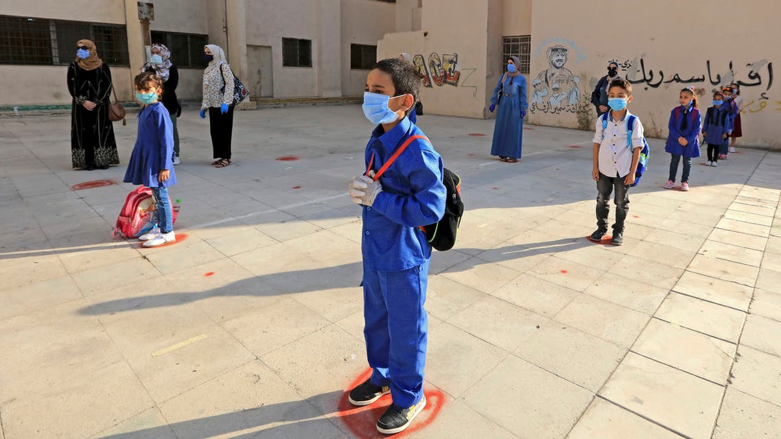 Students, wearing protective masks, wait in line on the first day of school in the Jordanian capital Amman amid the ongoing COVID-19 pandemic, on September 1, 2020. (File photo: AFP)