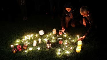People light candles during a vigil for Britain's MP David Amess, who was stabbed to death during a meeting with constituents, at the Belfairs Park in Leigh-on-Sea, Britain, on October 16, 2021. (Reuters)