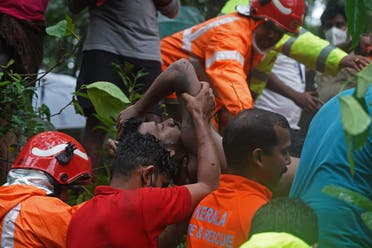 Members of fire and rescue team carry the body of a flash flood victim after heavy rains at Thodupuzha in India's Kerala state on October 16, 2021. (AFP)