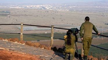 FILE PHOTO: Israeli soldiers look towards Syria across the border from Mount Bental before a visit by U.S. Secretary of State Mike Pompeo and Israeli Foreign Minister Gabi Ashkenazi in the Israeli-occupied Golan Heights November 19, 2020. Patrick Semansky/Pool via REUTERS/File Photo
