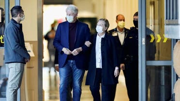 Former U.S. President Bill Clinton, accompanied by his wife, former Secretary of State Hillary Clinton, walks out of University of California Irvine Medical Center, in Orange, California, U.S. October 17, 2021. (Reuters)