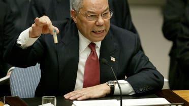 Secretary of State Colin Powell holds up a vial that he described as one that could contain anthrax, during his presentation on [Iraq] to the UNSC, Feb. 5, 2003. (Reuters)