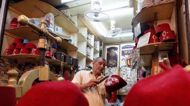 Fez maker, Nasser Abdel Basset, 60, works on a fez which is known in Arabic as Tarboush, at one of the very few remaining workshops in the old street of al-Ghoureya in Cairo, Egypt. (Reuters)
