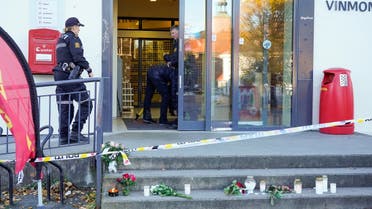 Police officers investigate at the Extra grocery store, where a man killed five people in the city on Wednesday night, in Kongsberg, Norway, on October 15, 2021.  (Reuters)
