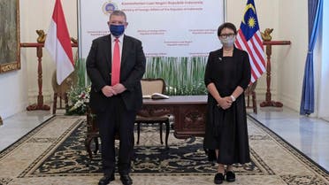 Malaysia’s Foreign Minister Saifuddin Abdullah (left), pose for a photograph with his Indonesian counterpart Retno Marsudi during their meeting in Jakarta, Indonesia, Oct 18, 2021. (AP)