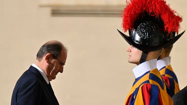 French Prime Minister Jean Castex (L) walks past Swiss Guard as he arrives at the Vatican on October 18, 2021 prior a meeting with the Pope. (AFP)