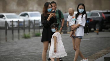 Women and a kid wearing face masks are seen on a street, following the outbreak of the coronavirus disease (COVID-19), in Beijing, China July 13, 2020. REUTERS/Tingshu Wang