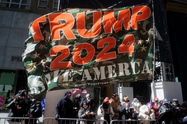 Supporters of former US President Donald Trump hold a “Trump 2024” flag as they attend a rally on 5th Avenue in front of Trump Tower upon news that Trump is staying in the city for a few days, in the Manhattan borough of New York City, New York, US, March 8, 2021. (Reuters)
