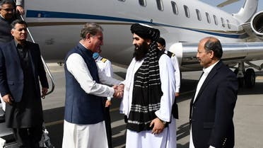 This handout photograph taken on October 21, 2021 and released by the Pakistan Foreign Office shows Afghanistan's acting Foreign Minister Amir Khan Muttaqi (2R) receiving Pakistan's Foreign Minister Shah Mahmood Qureshi (3L) upon his arrival at the airport in Kabul. (AFP)