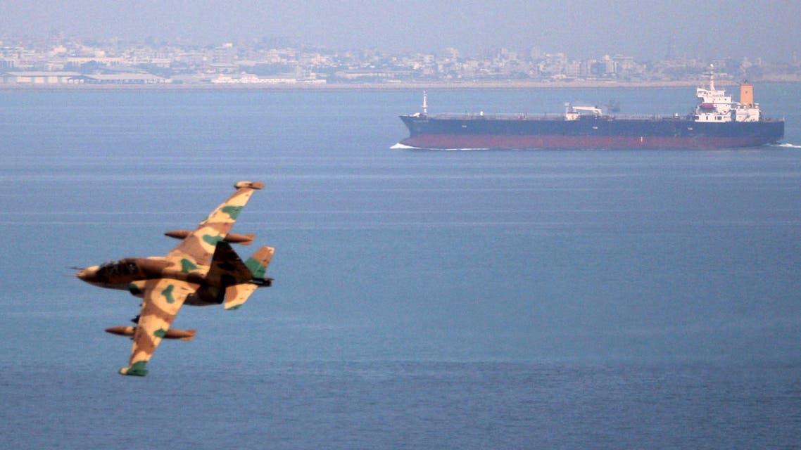 FILE PHOTO - An Iranian military fighter plane flies past an oil tanker during naval manoeuvres in the Gulf and Sea of Oman April 5, 2006. REUTERS/Fars News/File Photo