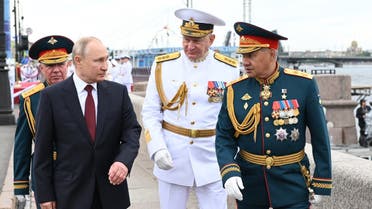 Russian President Vladimir Putin (2L), Western Military District Colonel-General Alexander Zhuravlev (L), Admiral Nikolai Yevmenov (C) and Russian Defense Minister Sergei Shoigu (R) attend the Navy Day parade in St. Petersburg on July 25, 2021. (AFP)