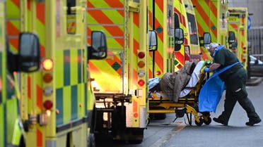 A paramedic is seen by a line of ambulances outside the Royal London Hospital in east London on January 5, 2021. (AFP)