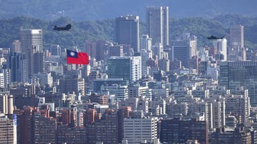 A Taiwan flag is carried by a Chinook helicopter during a rehearsal for the upcoming National Day celebration in Taipei, Taiwan October 7, 2021. REUTERS/Ann Wang