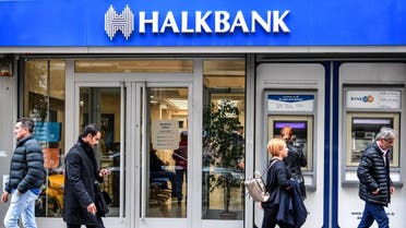 People walk past a branch of Halkbank on December 1, 2017 in Istanbul. (AFP)