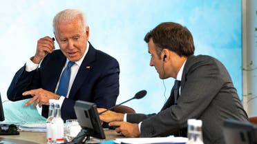 US President Joe Biden (L) talks with France's President Emmanuel Macron during a plenary session at the G7 summit in Carbis Bay, Cornwall on June 13, 2021. (AFP)