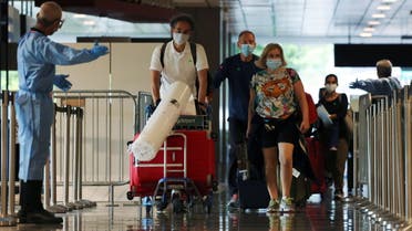 Passengers from Amsterdam arrive at Changi Airport under Singapore’s expanded Vaccinated Travel Lane (VTL) quarantine-free travel scheme, as the city-state opens its borders to more countries amidst the coronavirus disease (COVID-19) pandemic, in Singapore October 20, 2021. (Reuters)
